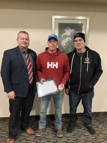 TJ King and Trent Marshall presenting Todd Stratychuk with his 25-year continuous service award.